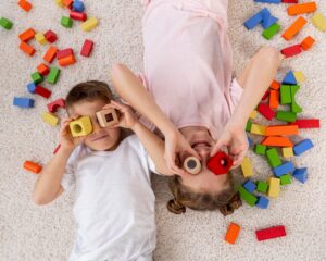 top-view-non-binary-kids-playing-with-colorful-game